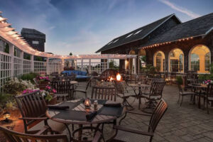 A photo of the patio with a lit fire pit at the DoubleTree
